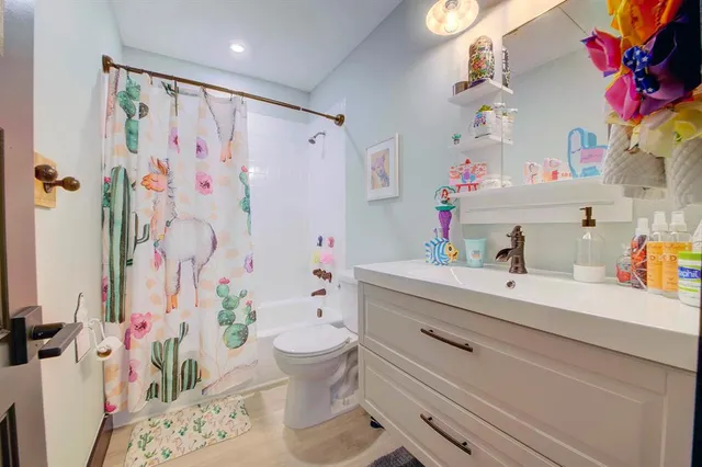 a bathroom with a sink toilet vanity and tub