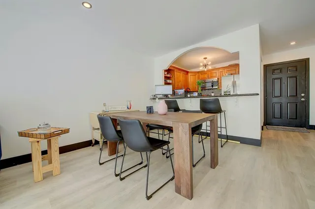 a view of a dining room with furniture and a chandelier