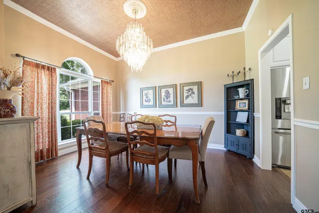 a view of a dining room with furniture wooden floor and chandelier