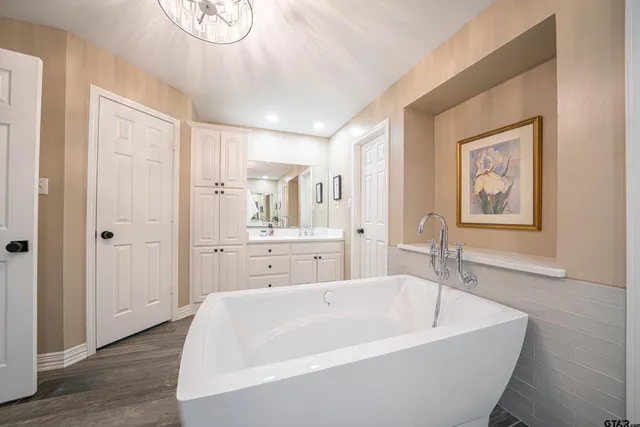 a spacious bathroom with a bathtub and shower