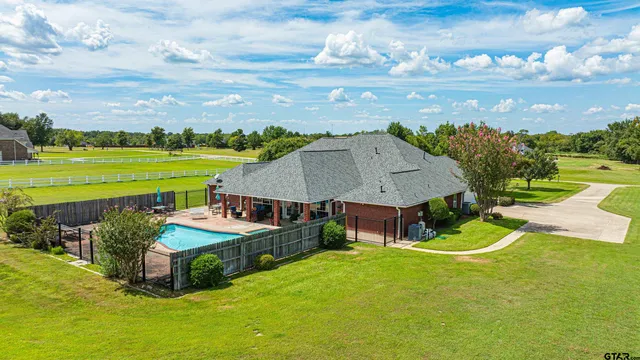 a aerial view of a house with big yard