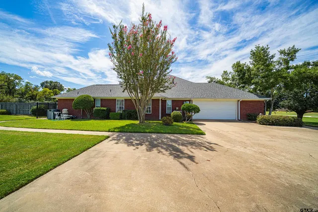 a front view of house with yard and green space