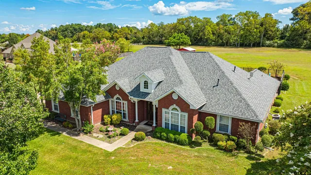a view of a house with swimming pool and a yard