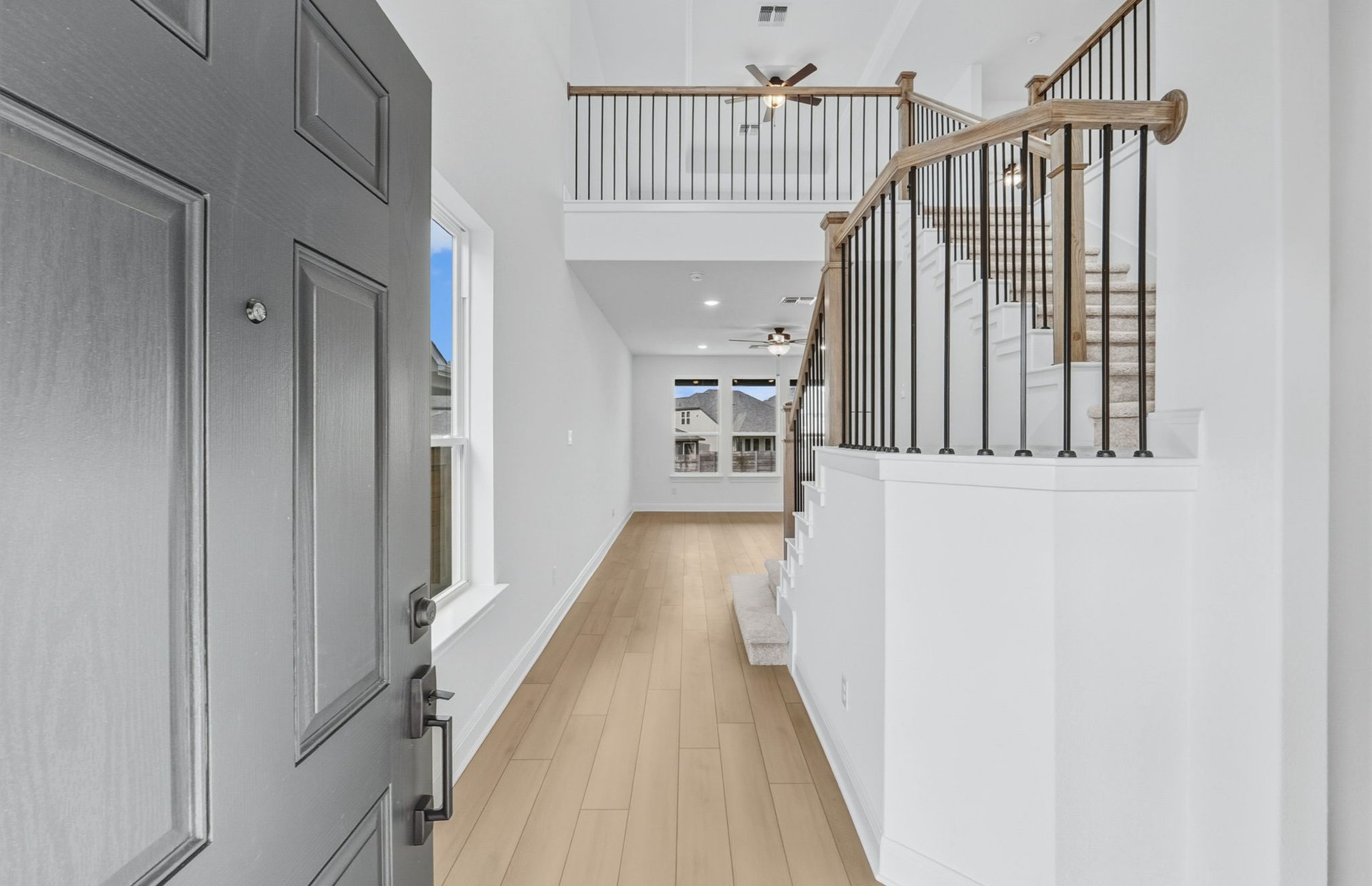 421 Foresail Road Leander, TX 78641 - Photo 11 of 28 a view of a hallway with wooden floor and staircase
