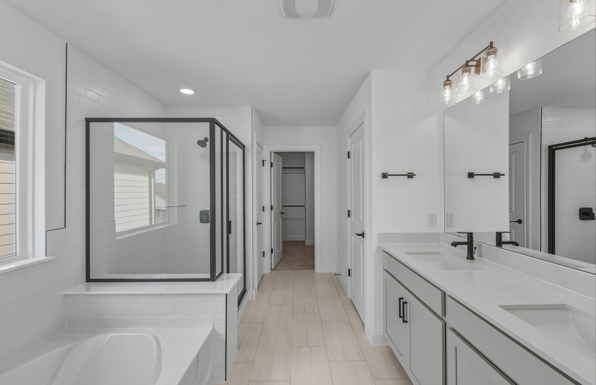 421 Foresail Road Leander, TX 78641 - Photo 15 of 28 a spacious bathroom with a double vanity sink mirror and shower