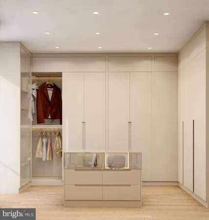 a view of a hallway with wooden floor and cabinet