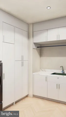 a view of a storage and utility room with washer and dryer