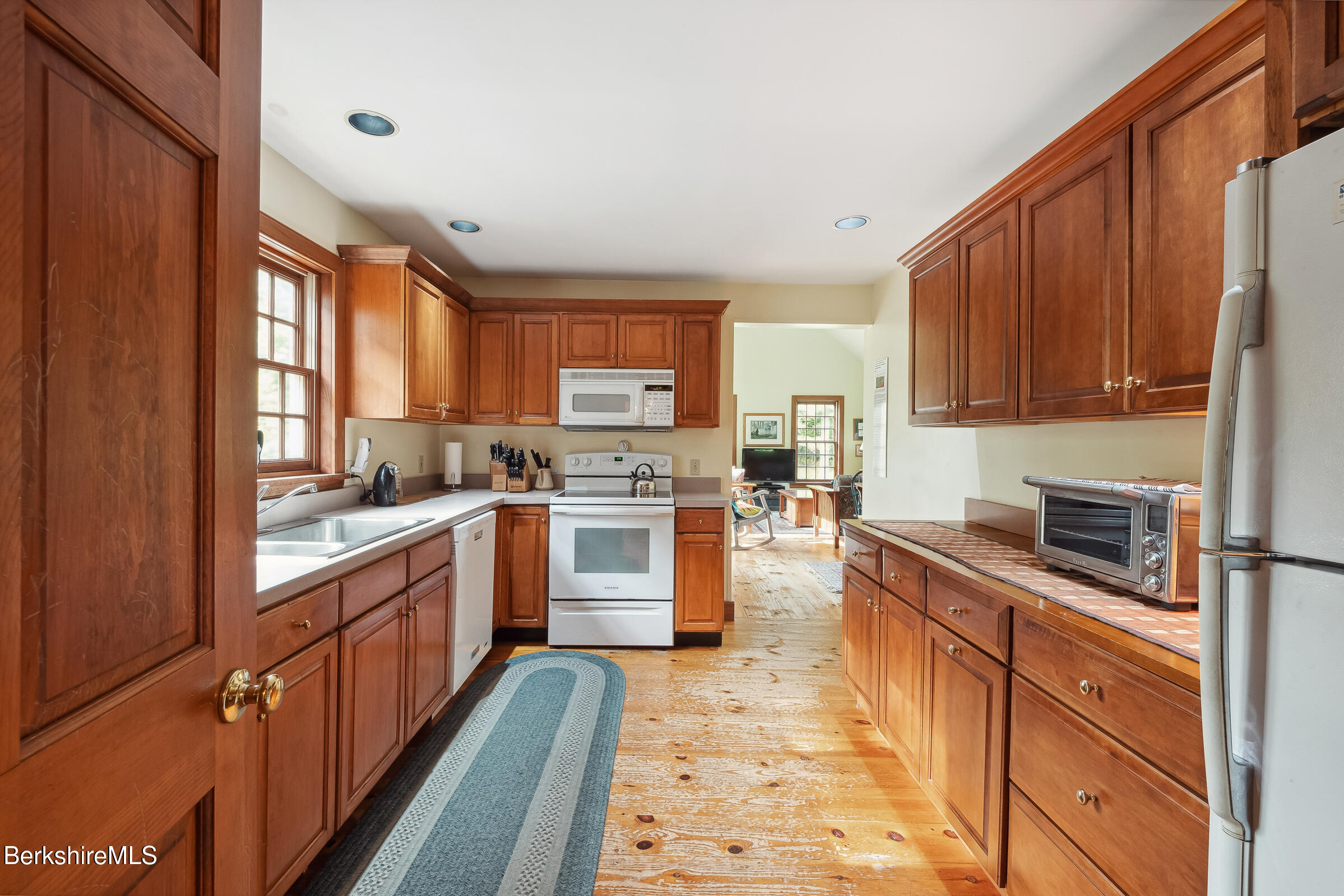 2205 County Rte 5 Canaan, NY 12029 - Photo 6 of 45 a kitchen with granite countertop wooden cabinets stainless steel appliances a sink and a window