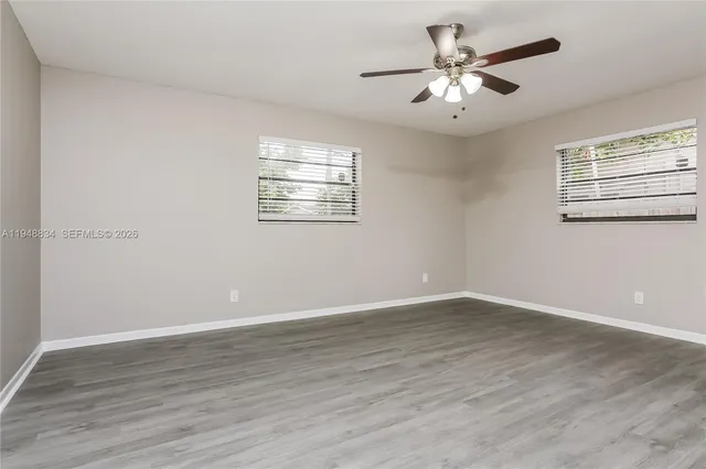 wooden floor in an empty room with a window