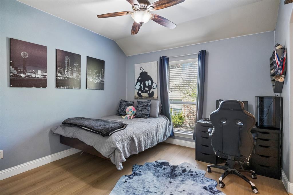 3917 Gatewick Drive Rockwall, TX 75087 - Photo 22 of 34 a bedroom with a bed and wooden floor