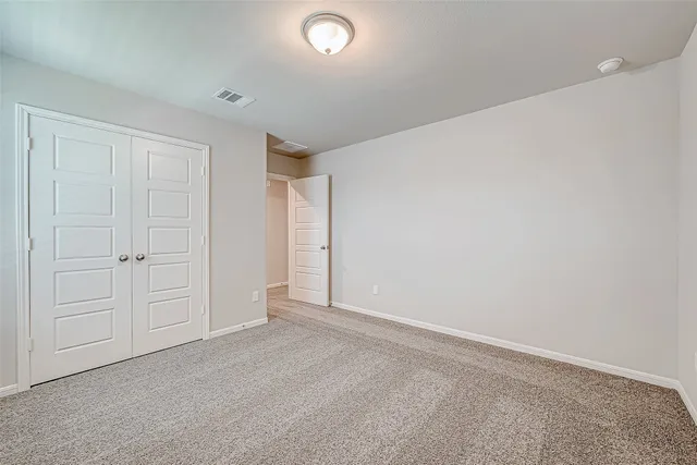 an empty room with closet area