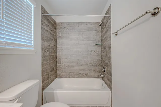 a bathroom with a shower and toilet