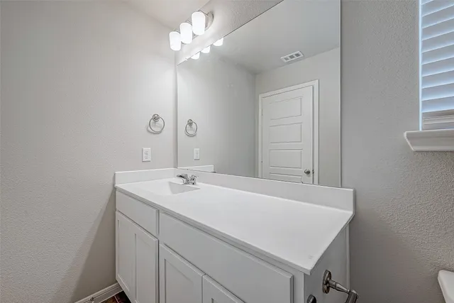 a bathroom with a sink a vanity and a mirror