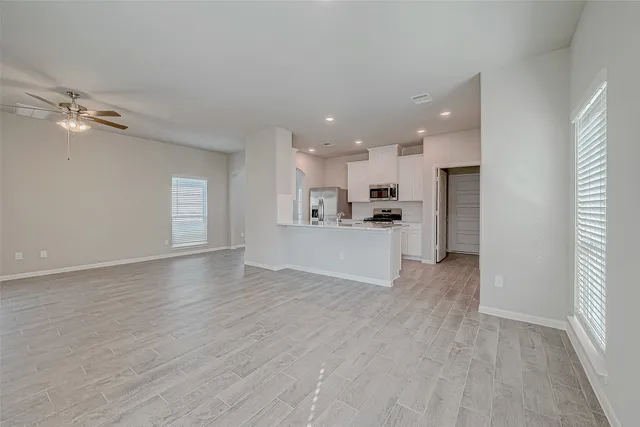 a view of a kitchen with a sink and a refrigerator