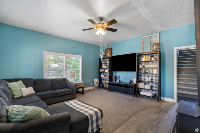 137 West 200 S Street Fairview, UT 84629 - Photo 9 of 34 Living area featuring a ceiling fan, window with blinds, and wood-finish flooring
