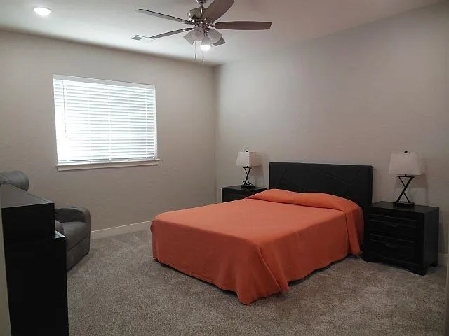 a bedroom with a bed and window