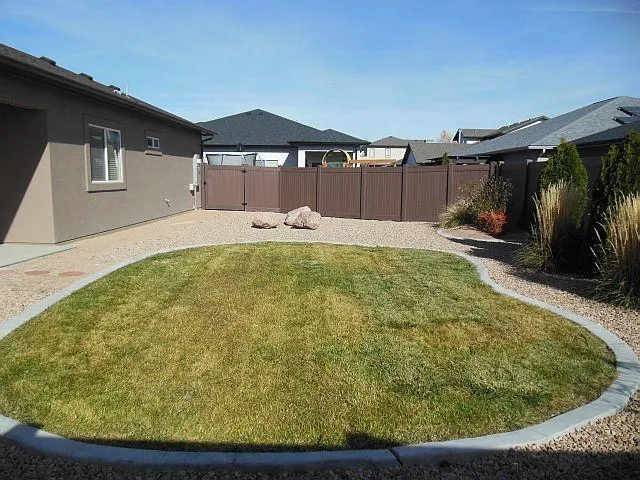 a view of a house with a backyard