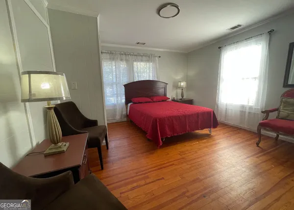 a bedroom with bed and window