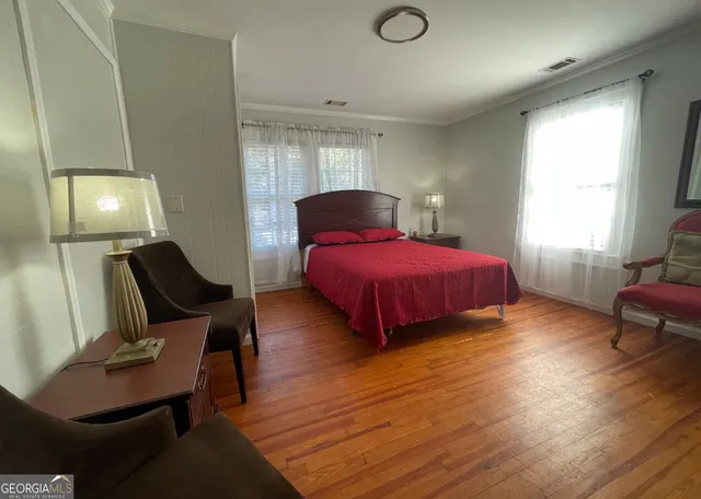 a bedroom with bed and window