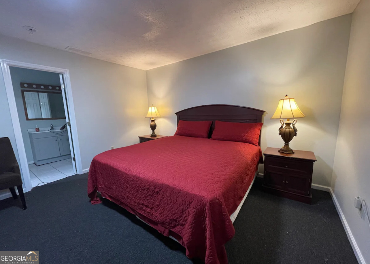 1401 Panola Road Stone Mountain, GA 30088 - Photo 12 of 15 a bed room with a bed and a lamp