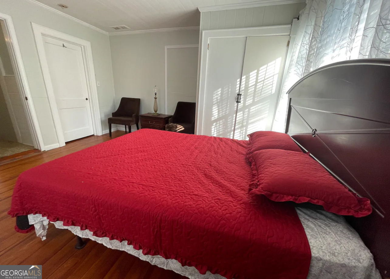 1401 Panola Road Stone Mountain, GA 30088 - Photo 14 of 15 a bed sitting in a bedroom next to a window