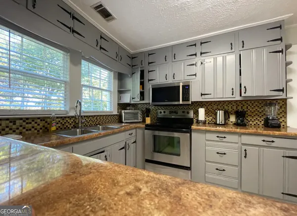 a kitchen with stainless steel appliances granite countertop a stove and a sink