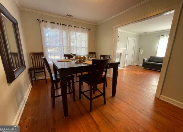 a view of a dining room with furniture and wooden floor