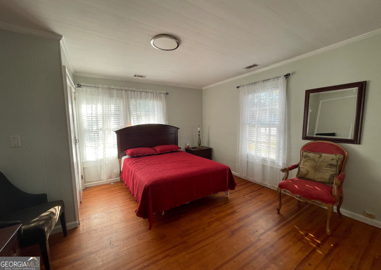 1401 Panola Road Stone Mountain, GA 30088 - Photo 6 of 15 a bedroom with a bed and wooden floor