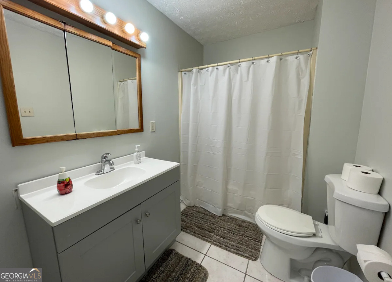 1401 Panola Road Stone Mountain, GA 30088 - Photo 7 of 15 a bathroom with a sink toilet and shower