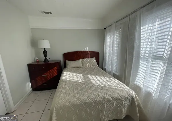 a bedroom with a bed and window