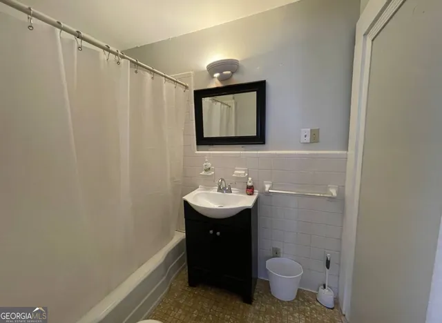 a bathroom with a sink toilet and mirror