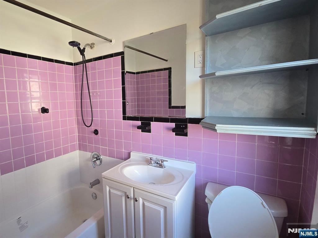 58 Hathaway Street, Unit 2 Wallington, NJ 07057 - Photo 6 of 9 a bathroom with a sink a toilet and shower