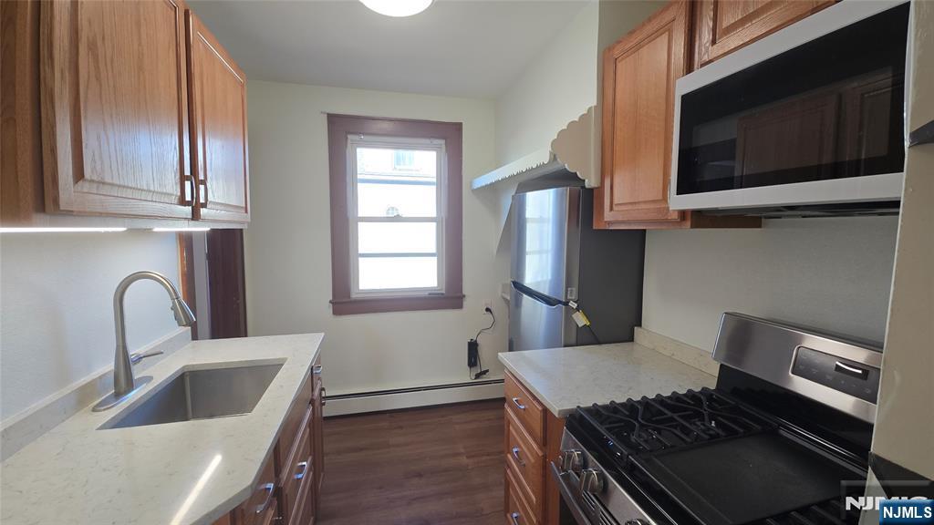 58 Hathaway Street, Unit 2 Wallington, NJ 07057 - Photo 7 of 9 a kitchen with stainless steel appliances granite countertop a sink and a stove