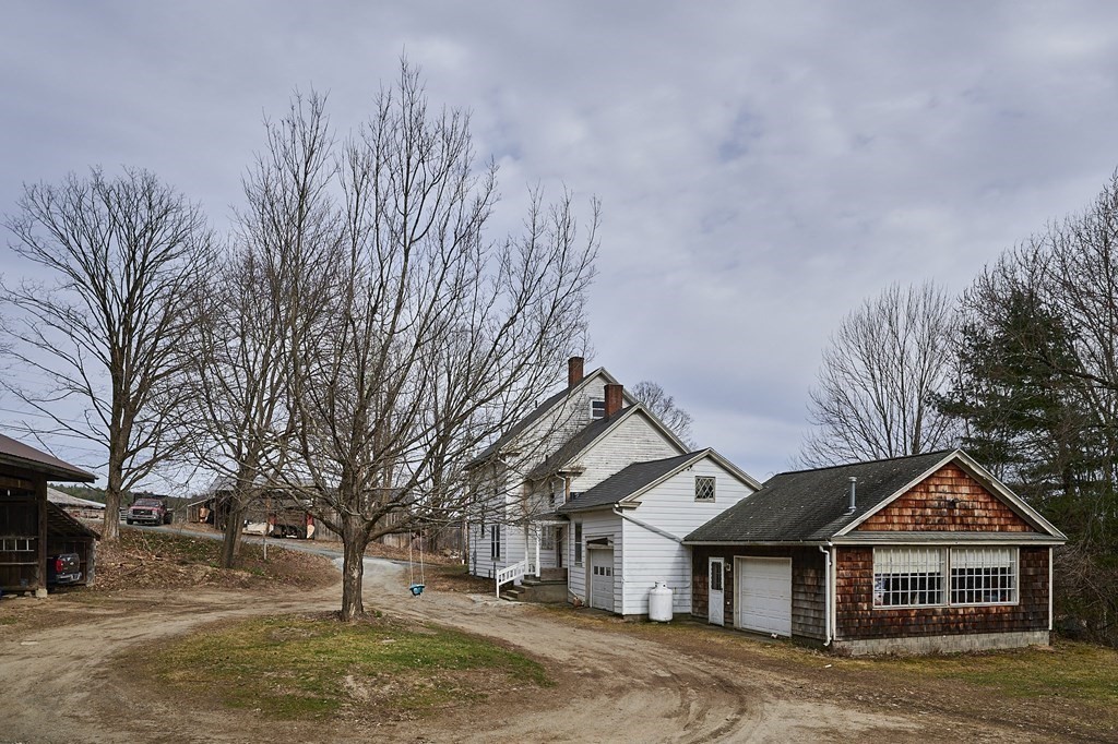21 Poplar Hill Road Haydenville, MA 01039 - Photo 23 of 42 a front view of a house with a yard and garage
