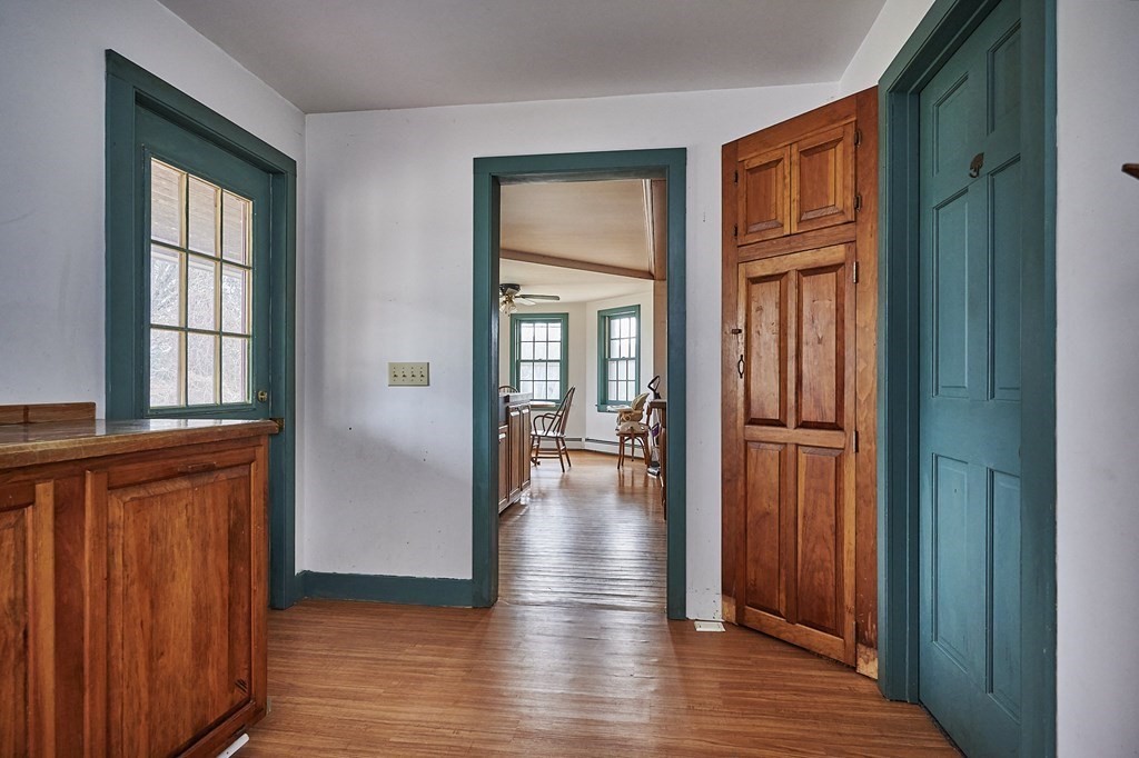 21 Poplar Hill Road Haydenville, MA 01039 - Photo 10 of 42 a view of a hallway with wooden floor and windows with curtains