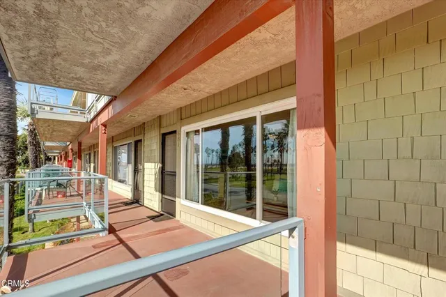 a view of a balcony with chair and floor to ceiling window