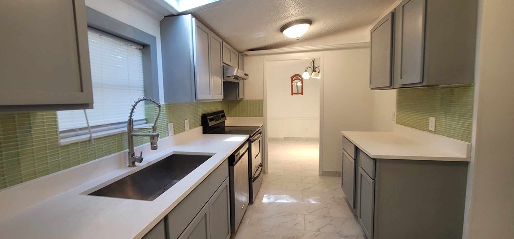 125 Sputnik Street Fortson, GA 31808 - Photo 9 of 30 a kitchen that has a sink and a stove