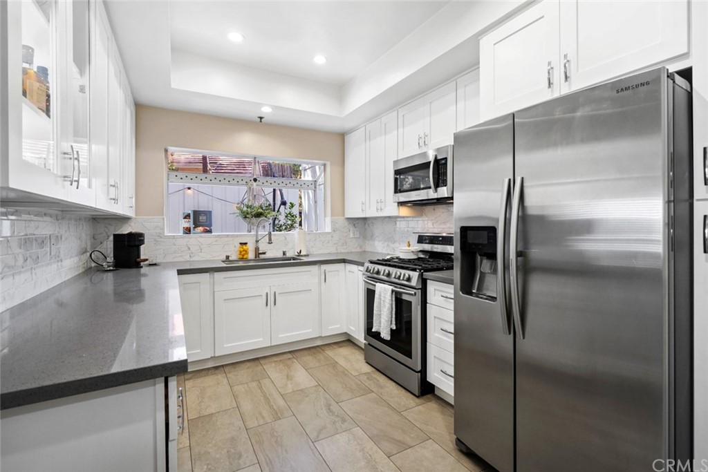 6255 Honolulu Avenue, Unit 23 Tujunga, CA 91042 - Photo 11 of 36 a kitchen with a refrigerator and a sink