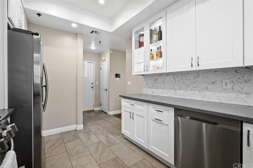 6255 Honolulu Avenue, Unit 23 Tujunga, CA 91042 - Photo 14 of 36 a kitchen with white cabinets and refrigerator