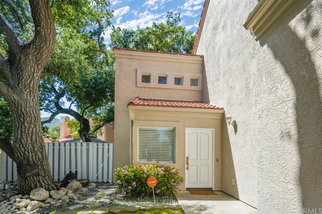 6255 Honolulu Avenue, Unit 23 Tujunga, CA 91042 - Photo 2 of 36 a front view of a house with a garden