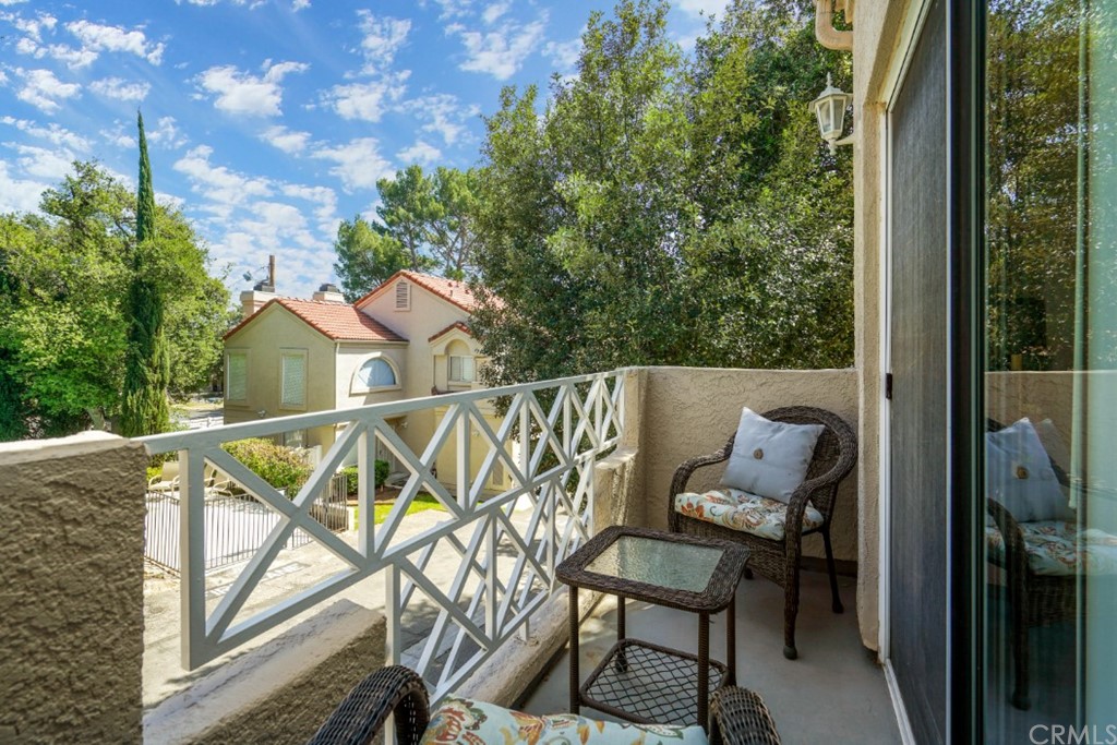6255 Honolulu Avenue, Unit 23 Tujunga, CA 91042 - Photo 29 of 36 a view of a wooden chairs and table in the balcony