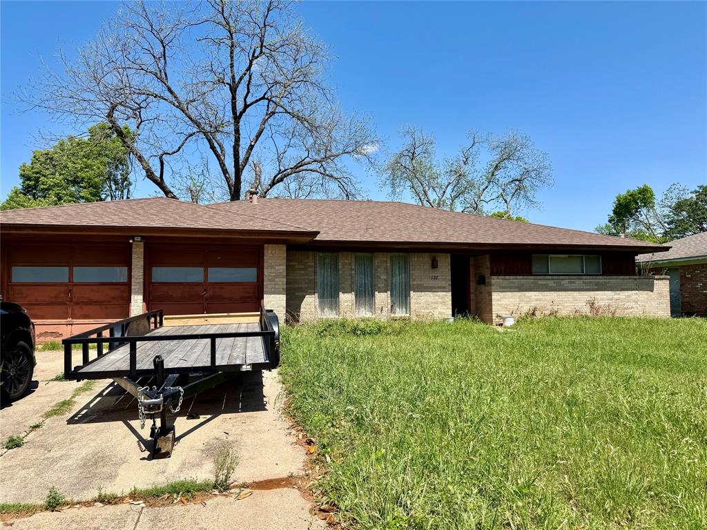 127 Kings Row Street Arlington, TX 76010 - Photo 1 of 1 a view of house with yard outdoor seating and covered with plants