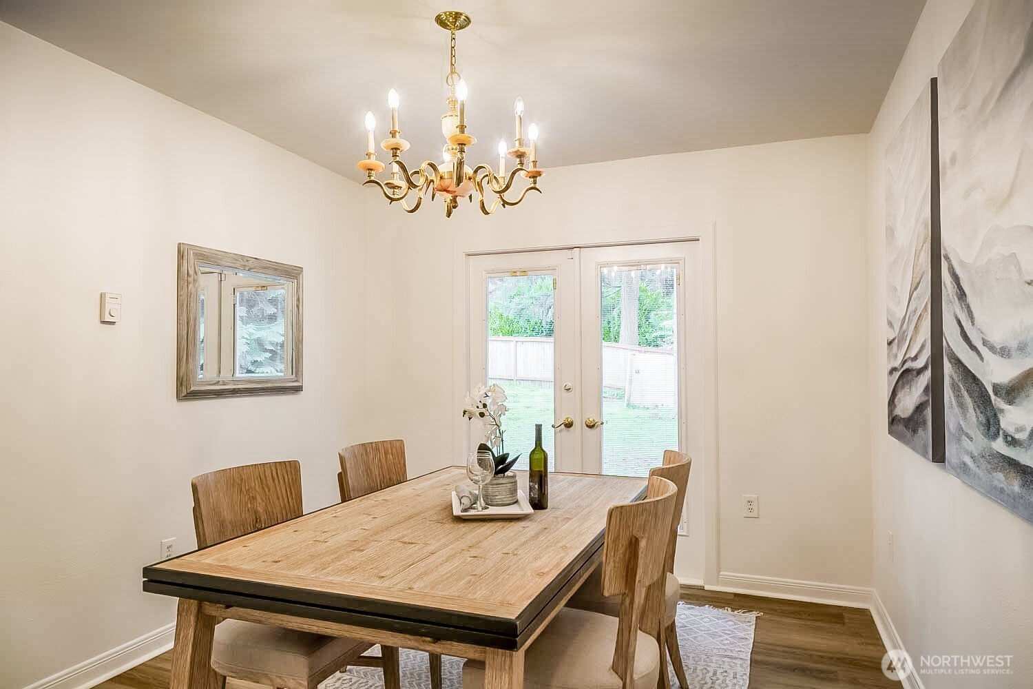 912 Northeast 115th Street Seattle, WA 98125 - Photo 9 of 21 a view of a dining room with furniture a chandelier and wooden floor