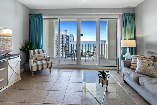 a living room with furniture and a floor to ceiling window