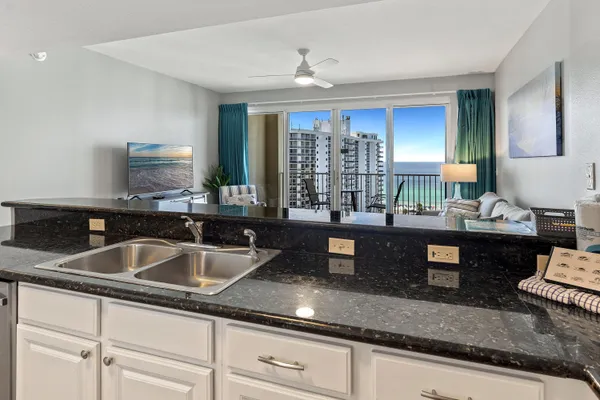 a kitchen with granite countertop a sink and a counter top space