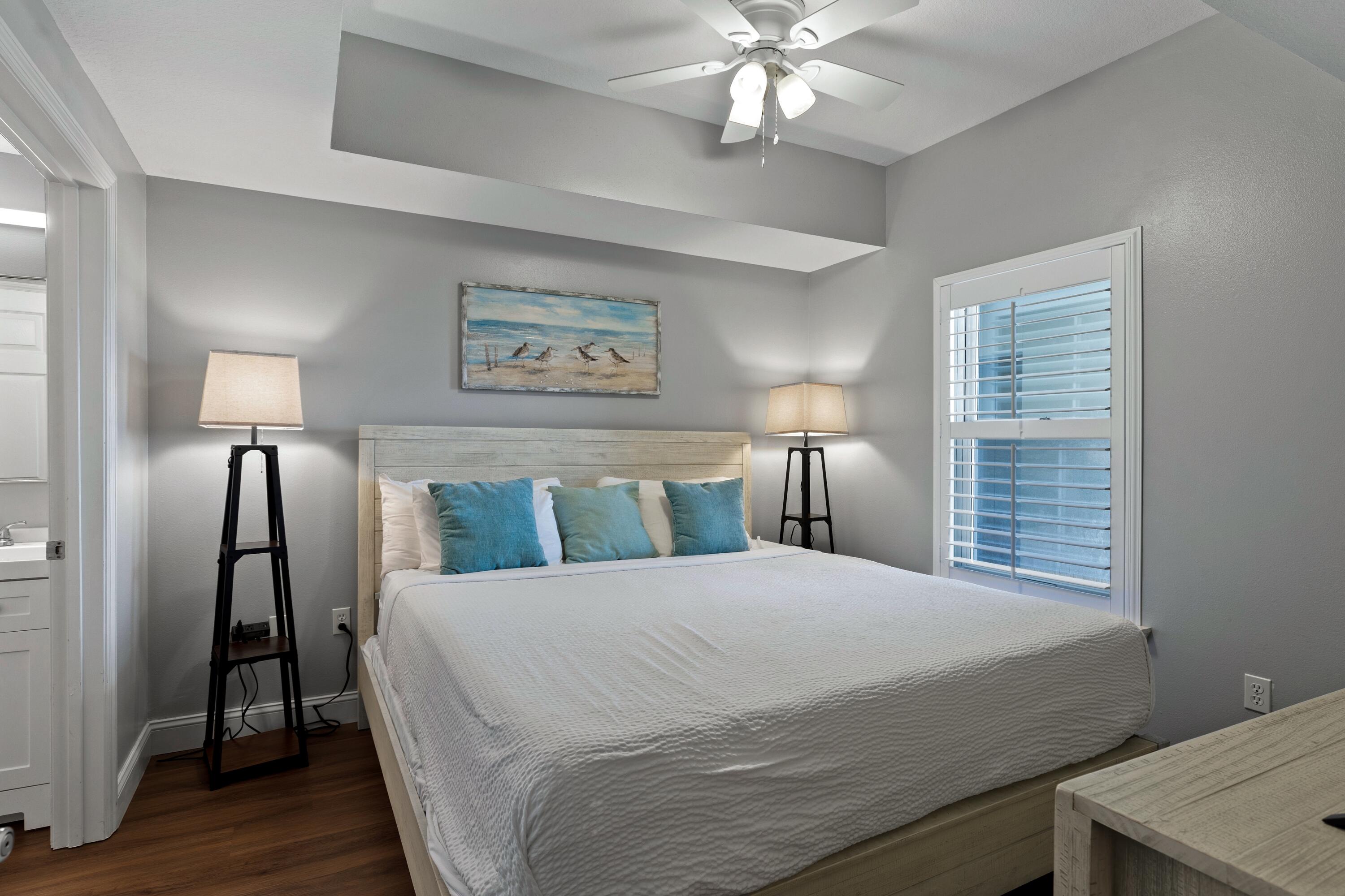 112 Seascape Drive, Unit 1306 Miramar Beach, FL 32550 - Photo 6 of 28 a bedroom with a bed and a chandelier