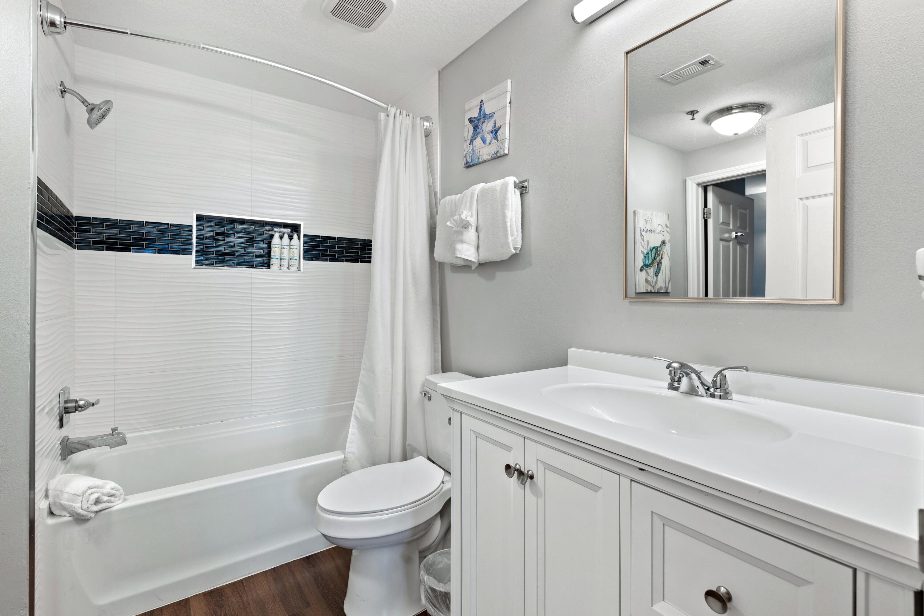 112 Seascape Drive, Unit 1306 Miramar Beach, FL 32550 - Photo 9 of 28 a bathroom with a sink a toilet and a bathtub