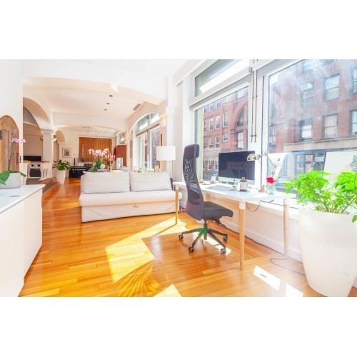 86 South Street, Unit 2A Boston, MA 02111 - Photo 16 of 24 a living room with fireplace furniture and a large window