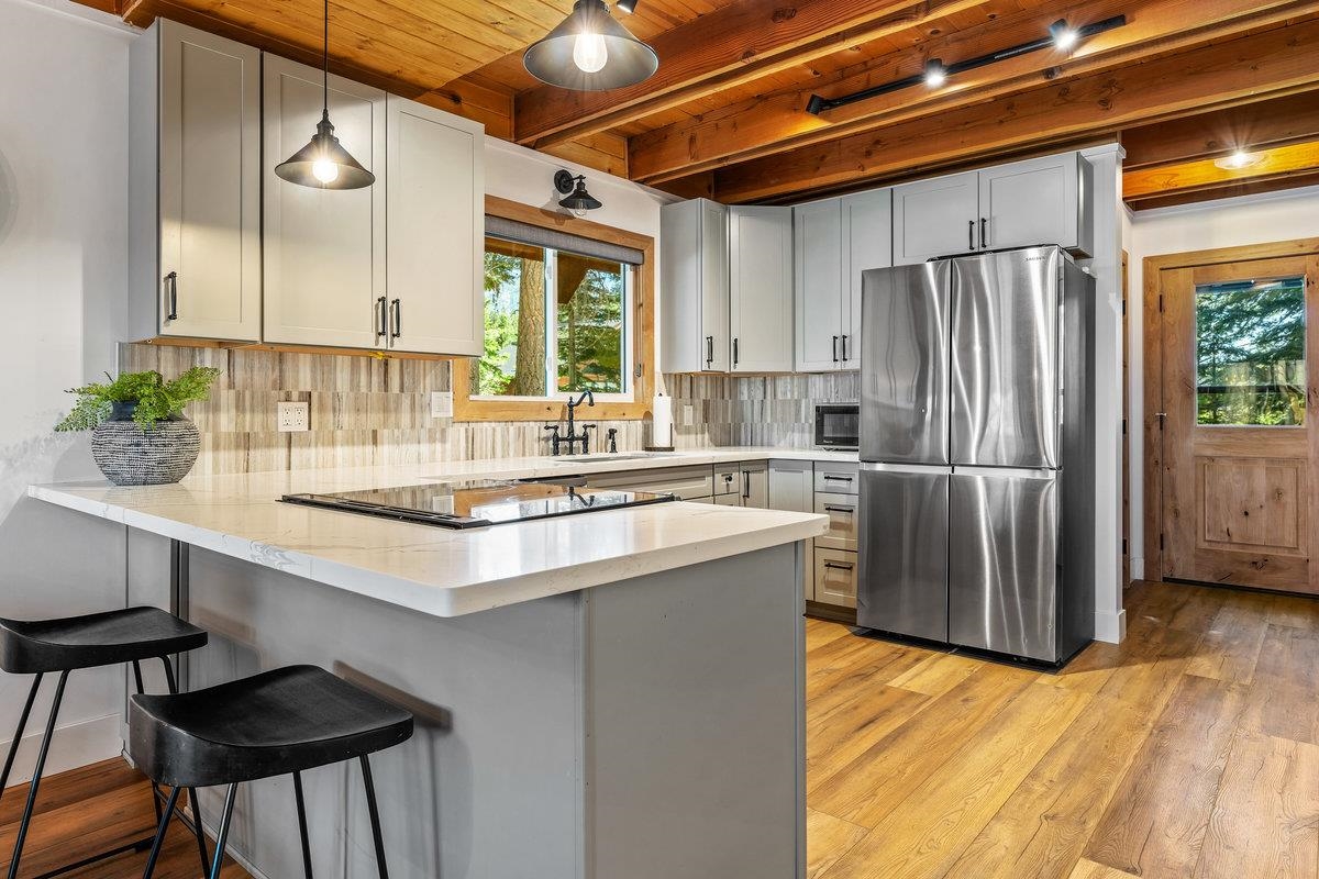 10175 Washoe Road Truckee, CA 96161 - Photo 7 of 20 a kitchen with stainless steel appliances granite countertop a sink refrigerator and cabinets