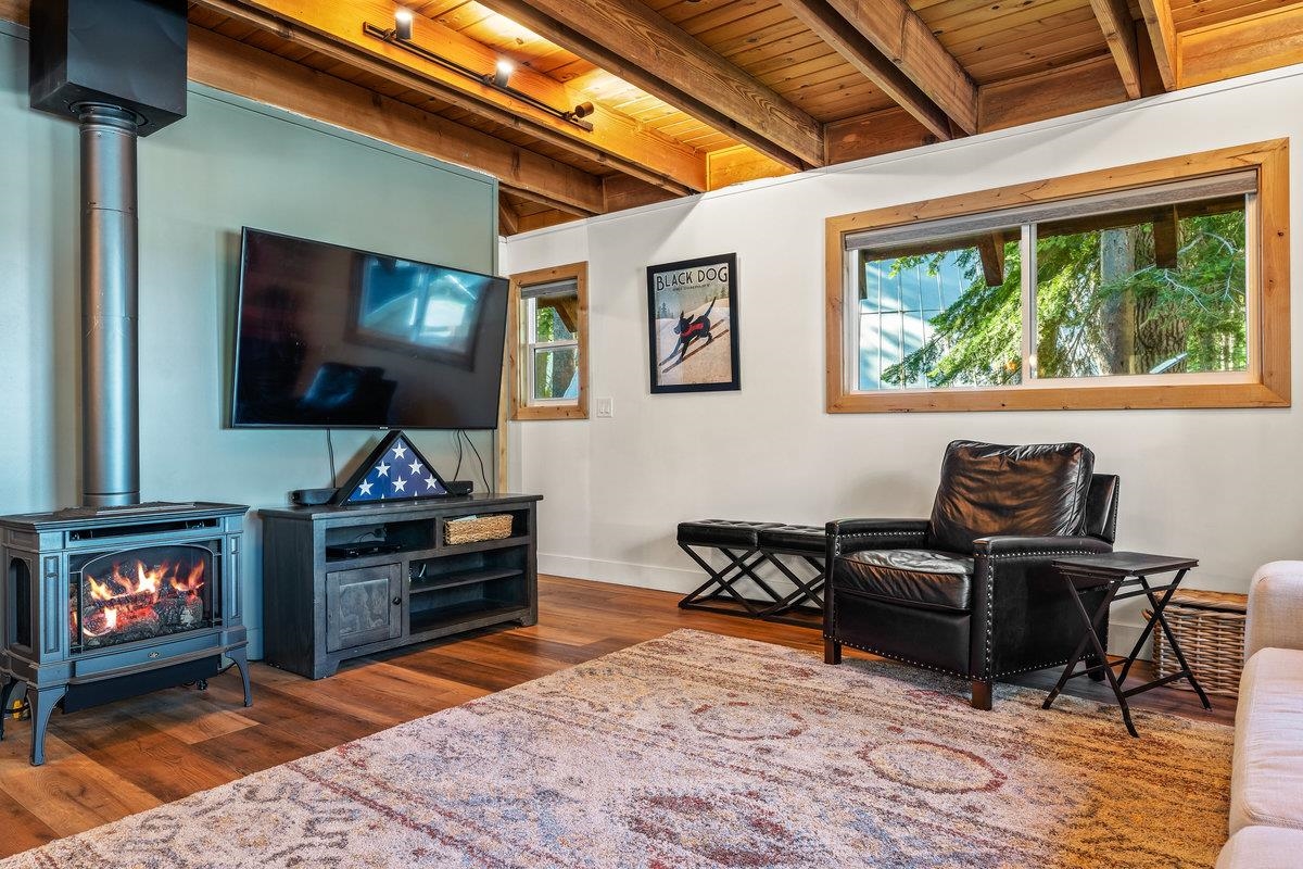 10175 Washoe Road Truckee, CA 96161 - Photo 9 of 20 a living room with furniture a flat screen tv and a fireplace